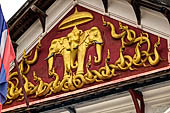 Luang Prabang, Laos  - Royal Palace, the pediment over the main entrance with the Airavata, the three-headed elephant, sheltered by the parasol and surrounded by intertwining naga guardians of the city. 